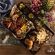  A tray filled with various dishes placed on a rustic wooden table, showcasing a delightful array of food.