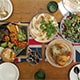  A beautifully arranged table featuring an array of food and drinks, inviting guests to enjoy a delightful meal together..